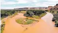  ?? FARMINGTON DAILY TIMES ?? The confluence of the thenorange Animas River on the left with the unfouled San Juan River on the right after the Gold King Mine spill in August 2015.