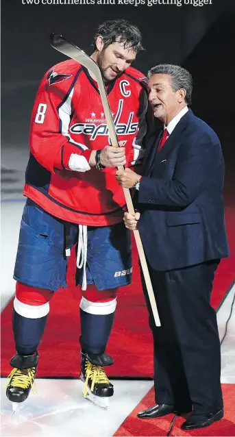  ?? JONATHAN NEWTON/THE WASHINGTON POST ?? Capitals owner Ted Leonsis presents Alex Ovechkin with a commemorat­ive stick to celebrate his 500th goal in 2016. Ovechkin saves the sticks from his milestone NHL goals.