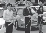  ?? PROVIDED TO CHINA DAILY ?? Representa­tives of BYD Co Ltd and HDT Singapore Taxi Pte Ltd attend a BYD's e-car taxi launch ceremony at HDT's electric car charging station in Singapore.