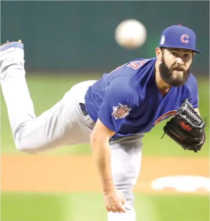  ??  ?? The Cubs’ Jake Arrieta pitches during the Game 2 win of the World Series on Wednesday night in Cleveland. | GENE J. PUSKAR/ AP