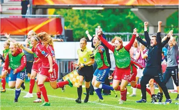  ??  ?? Denmark’s head coach Nils Nielsen (R) and players react after winning the quarter-final UEFA Women’s Euro 2017 football match against Germany at Stadium Sparta Rotterdam in Rotterdam on July 30, 2017. - AFP photo