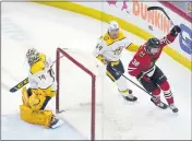  ?? CHARLES REX ARBOGAST — THE ASSOCIATED PRESS ?? Chicago’s Brandon Hagel, right, celebrates his overtime goal past Nashville goaltender Juuse Saros on Wednesday.