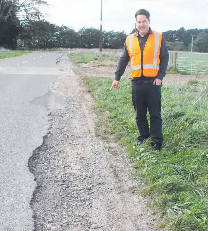  ??  ?? MANAGER of the Tararua Alliance Chris Chapman points to a typical spot on Ballance Valley Road where trucks have worn away the bitumen.
