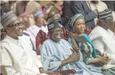  ??  ?? Nigeria’s President Muhammadu Buhari (L) speaks with Asiwaju Bola Tinubu (2nd L) after listening the national anthem during the Bola Tinubu Colloquium in Lagos on Thursday. Buhari was attending the 10th Colloquium organised to celebrate the Leader of...