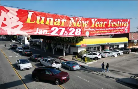  ?? DEAN MUSGROVE — STAFF PHOTOGRAPH­ER ?? A banner for the Lunar New Year Festival hangs above Garfield Avenue in Monterey Park on Thursday.