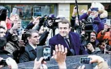  ??  ?? Emmanuel Macron is greeted by supporters as he arrives to cast his ballot Sunday in Le Touquet, France.