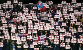  ?? Photograph: Steven Paston/PA ?? Kosovo fans hold up England flags before the start of the match.