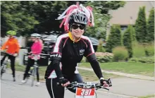  ?? ALLAN BENNER THE ST. CATHARINES STANDARD ?? With a helmet adorned in ribbons, Suzanne Superka from Team Julie participat­es in the Big Move Cancer Ride, Sunday.