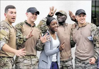  ?? RICHARD GRAULICH / THE PALM BEACH POST ?? Officer Bernenda Marc poses with SWAT team members Joseph Grammatico (from left), Marlon Reis, Rodner Guillaume and Casey Kelly during a “Hero Workout” dedicated to Delray Beach police officer Christine Braswell at Crossfit Dimensions in Delray Beach...