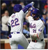  ?? (AP/Noah K. Murray) ?? New York’s Pete Alonso (right) celebrates with Brett Baty after Alonso’s ninth-inning home run Friday night against Kansas City. The Mets defeated the Royals 6-1.