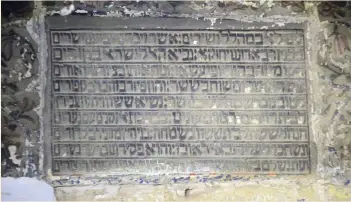  ??  ?? HEBREW IS written on the wall in the shrine containing the tomb of the prophet Ezekiel in the Iraqi town of Kifl, south of Baghdad.
