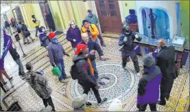  ?? FBI ?? In this security video clip from the Jan. 6 insurrecti­on at the U.S. Capitol, the FBI identified the person wearing the bright orange sweatshirt as Ronald Sandlin.