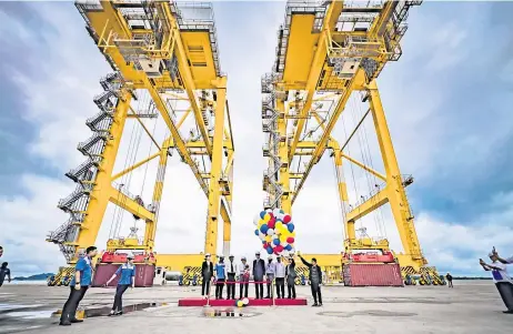  ?? — Photo by Roystein Emmor ?? Photo shows the two new quay cranes, meant to augment the operationa­l efficiency and capacity of facilities of Kuching Port.