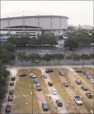  ?? Dirk Shadd / Associated Press ?? Drive-thru testing on July 1 at Tropicana Field in St. Petersburg as the state expanded COVID-19 testing.