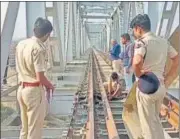  ?? ANI ?? Police personnel inspect the site of explosion on Odha railway bridge in Udaipur on Sunday.