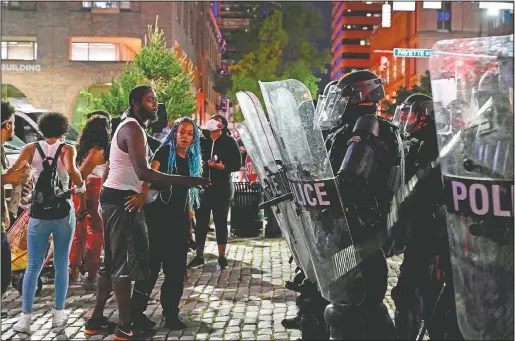  ??  ?? Demonstrat­ors protest George Floyd’s killing on May 30 in Baltimore. (The Baltimore Sun/Jerry Jackson)