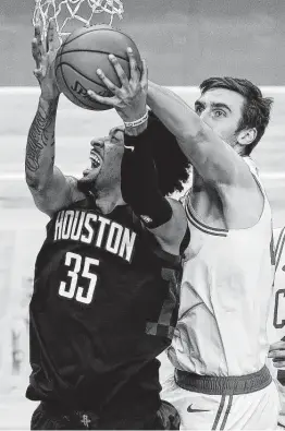  ?? Winslow Townson / Associated Press ?? Christian Wood, who led the Rockets with 19 points, gets blocked by the Celtics’ Luke Kornet during the third quarter on Friday in Boston.