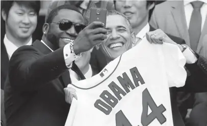  ??  ?? Boston Red Sox designated hitter David Ortiz poses for a ‘selfie’ with President Obama during a ceremony on the South Lawn of the White House to honor the 2013 World Series Champion Boston Red Sox.