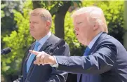  ?? SUSAN WALSH/ASSOCIATED PRESS ?? President Donald Trump calls on a reporter Friday during a news conference with Romania’s President Klaus Iohannis in the Rose Garden of the White House.