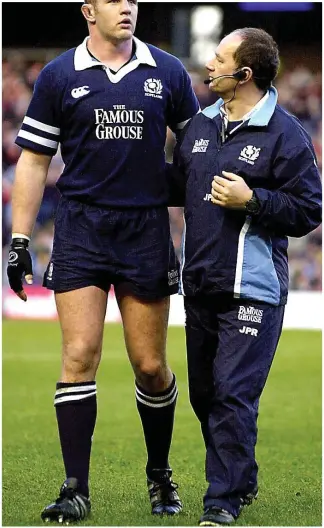  ??  ?? One blow too many: White (left) is helped off the field by Dr James Robson during an internatio­nal in 2002 where the forward showed clear signs of a bad concussion
