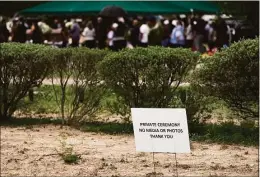  ?? Jae C. Hong / Associated Press ?? A sign asking the media for privacy stands outside Hillcrest Cemetery during a burial service for one of the victims killed in the elementary school shooting on May 24, in Uvalde, Texas, on Wednesday.