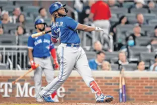  ?? DALE ZANINE • USA TODAY SPORTS ?? Toronto Blue Jay Vladimir Guerrero Jr. hits a home run against the Atlanta Braves on May 12. Major League Baseball generates data points every game that can be leveraged by marketing them to sports wagering sites.