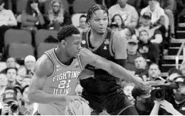  ?? AP ?? Illinois’ Kofi Cockburn (21) works the ball inside with Houston’s J’Wan Roberts defending during the first half of a college basketball game in the second round of the NCAA tournament in Pittsburgh, Sunday, March 20, 2022.