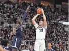  ?? ERIC CANHA/USA TODAY SPORTS ?? Providence forward Josh Oduro (13) shoots over Georgetown forward Supreme Cook (24) during the first half at Amica Mutual Pavilion on Saturday.