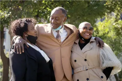  ?? PAT NABONG/SUN-TIMES FILE ?? Jackie Wilson, his wife, Sandra, and niece Candace gather outside Cook County Criminal Court in 2020. Wilson on March 14 received a $17 million settlement from the county, but Chicago is still fighting the case.