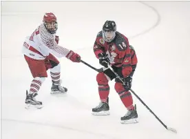  ?? BOB TYMCZYSZYN THE ST. CATHARINES STANDARD ?? Niagara Falls Canucks captain Ben Evans, right, is checked by St. Catharines Falcons forward Jaleel Adams in season-opening junior B hockey Friday night at Jack Gatecliff Arena in St. Catharines.