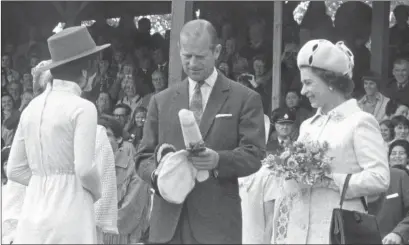  ?? Photo credit: Kelowna Public Archives #4955 ?? Prince Philip and Queen Elizabeth drew thousands of people to Kelowna’s City Park during a visit in July 1971. An inattentiv­e bandmaster drew Philip’s rebuke during the reception.
