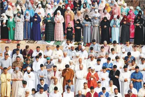  ?? Reuters ?? People attend Eid Al Fitr prayers to mark the end of Ramadan at a playground in the suburb of Sale, Morocco.