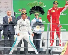  ?? /Stefano Rellandini, Reuters ?? Strutting his stuff: Lewis Hamilton celebrates winning the 2018 Italian Grand Prix with runnerup Kimi Raikkonen, right, of Ferrari.