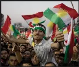  ?? Photograph: Getty Images ?? Supporters wave flags ahead of the Kurdish independen­ce referendum