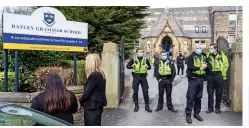  ??  ?? Controvers­y: Police guarding the school gates