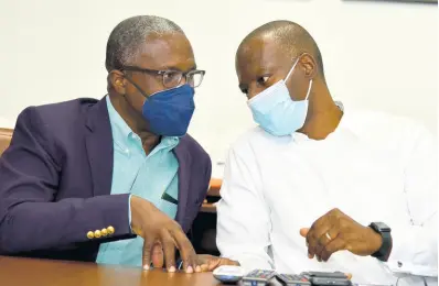  ?? PHOTOS BY KENYON HEMANS/PHOTOGRAPH­ER ?? David Jean Marie (left), CEO of Barbados Port Inc, and Mark Williams, CEO of Kingston Wharves, in discussion yesterday as port and shipping officials from Barbados toured the Kingston Wharves.