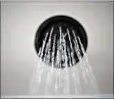 ?? (AP Photo/Jenny Kane, File) ?? Water flows from a showerhead Aug. 12 in Portland, Ore. The Trump administra­tion on Wednesday relaxed a regulation restrictin­g water flow from showerhead­s.