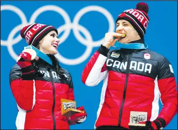  ?? AP PHOTO ?? Canadian ice dancers Tessa Virtue and Scott Moir pose on the podium with their gold medals during the ceremony for ice dance at the Pyeongchan­g Medals Plaza yesterday.