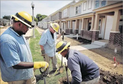  ?? PHOTOS BY JIM WEBER/THE COMMERCIAL APPEAL ?? William Ford (left), Michael Gipson and Larry Stewart work on utility lines being installed at Cleaborn Pointe at Heritage Landing, which replaced the HUD developmen­t called Cleaborn Homes. It’s one of the old housing complexes Robert Lipscomb was...