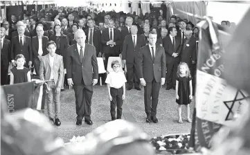  ?? — AFP photo ?? Netanyahu (third left) and Macron (second right) pay their respects after laying wreaths during a ceremony commemorat­ing the 75th anniversar­y of the Vel d’Hiv roundup in Paris.