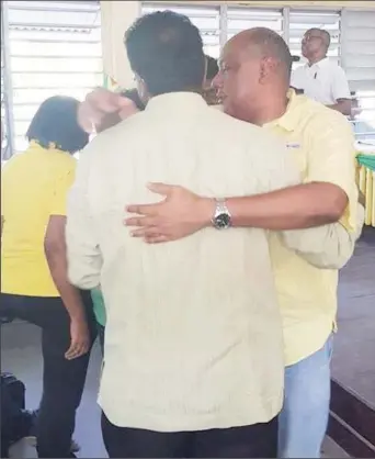  ?? (Photo taken from Moses Nagamootoo’s ?? New leader Raphael Trotman (at right) and his predecesso­r Khemraj Ramjattan embrace after the vote. Facebook page)
