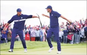  ?? Richard Heathcote / Getty Images ?? The United States’ Bryson DeChambeau, left, and Scottie Scheffler celebrate on the 15th green during the Saturday afternoon fourball matches at the Ryder Cup at Whistling Straits in Kohler, Wis.