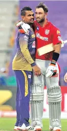  ??  ?? KXIP's Glenn Maxwell (right) hugs Sunil Narine of KKR after the last ball thriller