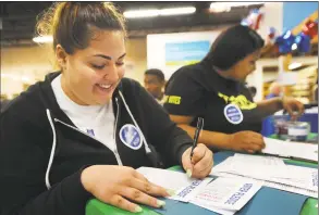  ?? Brian A. Pounds / Hearst Connecticu­t Media file photo ?? Julissa Santiago, left, and Tiana Krause, both of Bridgeport, fill out voter pledge cards during a National Voter Registrati­on Day event at the Habitat for Humanity ReStore in Stratford on Sept. 25, 2018. Fairfield County’s Community Foundation’s Get Out the Vote Program has awarded 18 grants to civic-minded organizati­ons to energize and educate the community to vote.