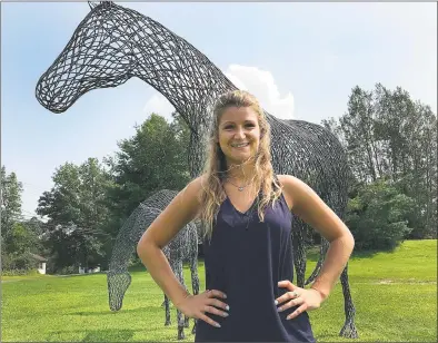  ?? Chris Bosak / Hearst Connecticu­t Media ?? Dana Ferraro, Brookfield's new community developmen­t specialist in the Land Use Department, stands by the horses outside of Brookfield Town Hall on Thursday.