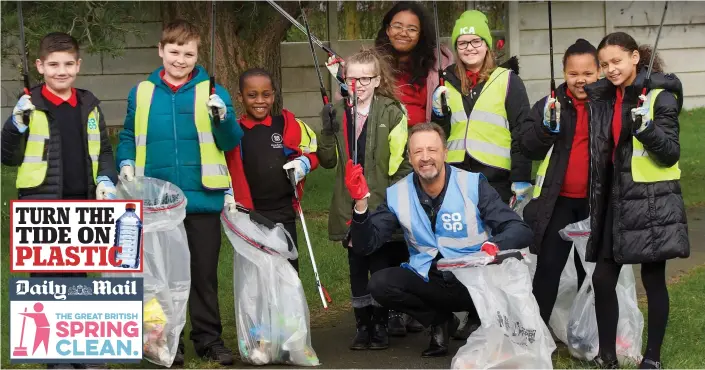 ??  ?? Clean sweep: Co-op chief executive Steve Murrells joins a band of Broadhurst primary school pupils armed with litter-pickers and bags in a Manchester park