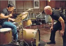  ?? Daniel McFadden Sundance ?? J.K. SIMMONS, right, plays a sadistic jazz teacher training a student drummer, played by Miles Teller, in “Whiplash.”