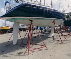  ??  ?? Today’s state-of-theart storm-proof marina installati­ons include storm cradles and tie-down straps (top) and extra jack stands (above). Tie-down straps attach to eyes or rings securely set in concrete for added security (right).