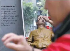  ?? EYE PARLOUR: ?? Xiong Gaowu, a 62-year old street barber, cleans his customer’s eye using a silver stick in Chengdu, Sichuan province, China. — Reuters