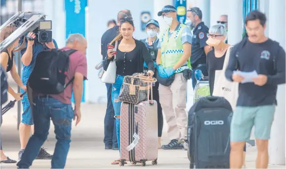  ?? Picture: GLENN CAMPBELL ?? Travellers arriving at Darwin Internatio­nal Airport face long waits to find if they can claim quarantine exemption